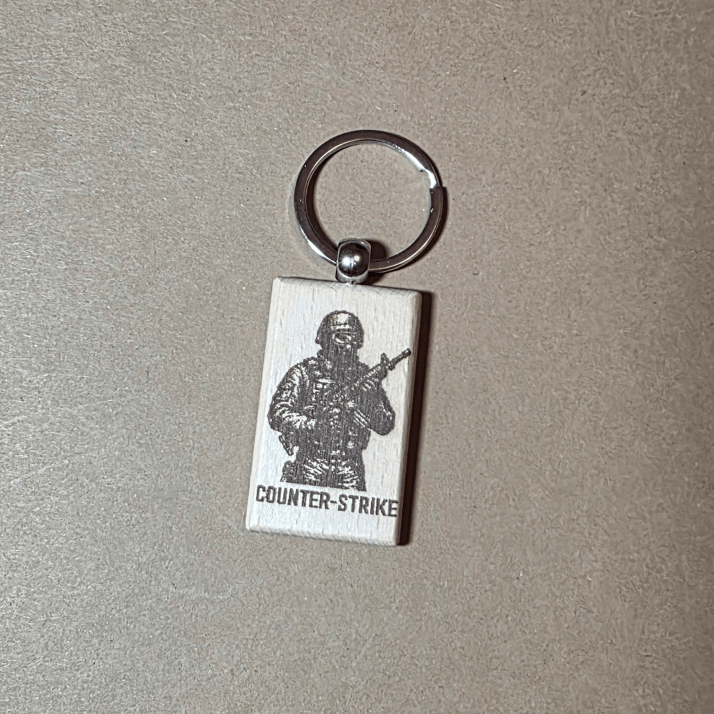Counter-Strike laser engraved wooden keychain on neutral background