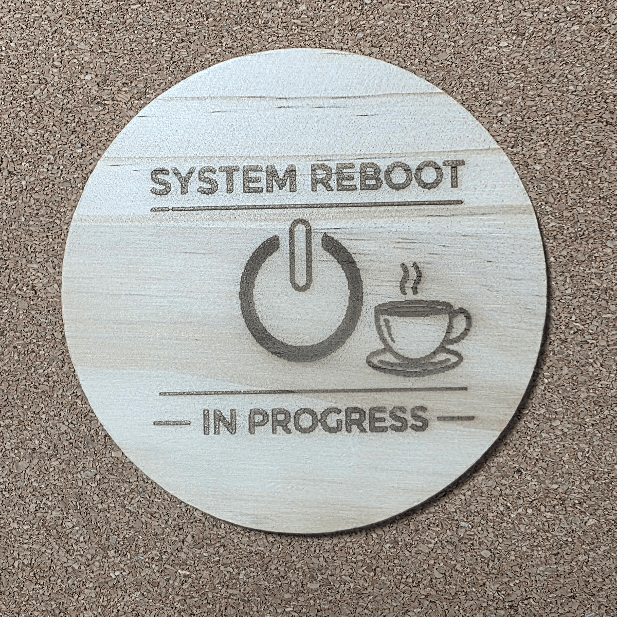 Funny coffee coaster ‘SYSTEM REBOOT / IN PROGRESS’ with power button icon, engraved wooden coaster