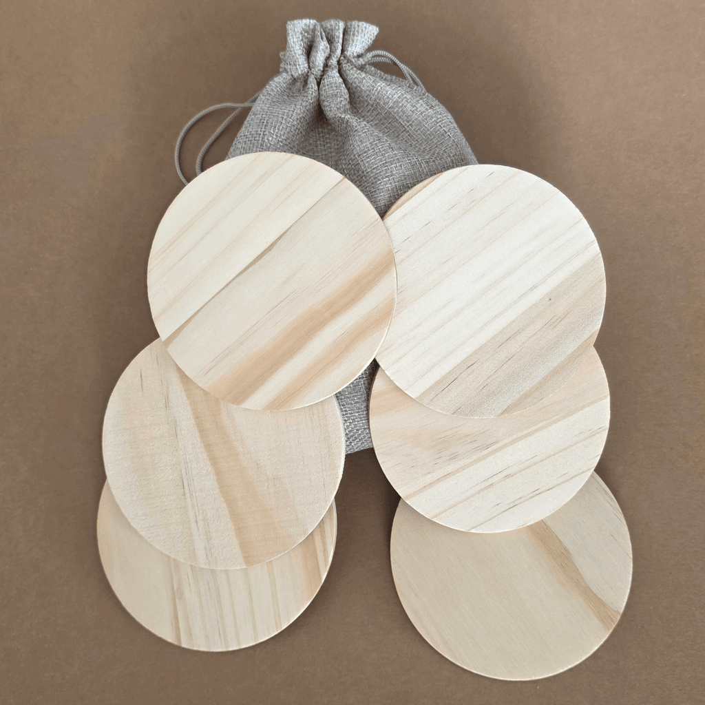 Set of six natural round wooden coasters with rubber feet and gift pouch
