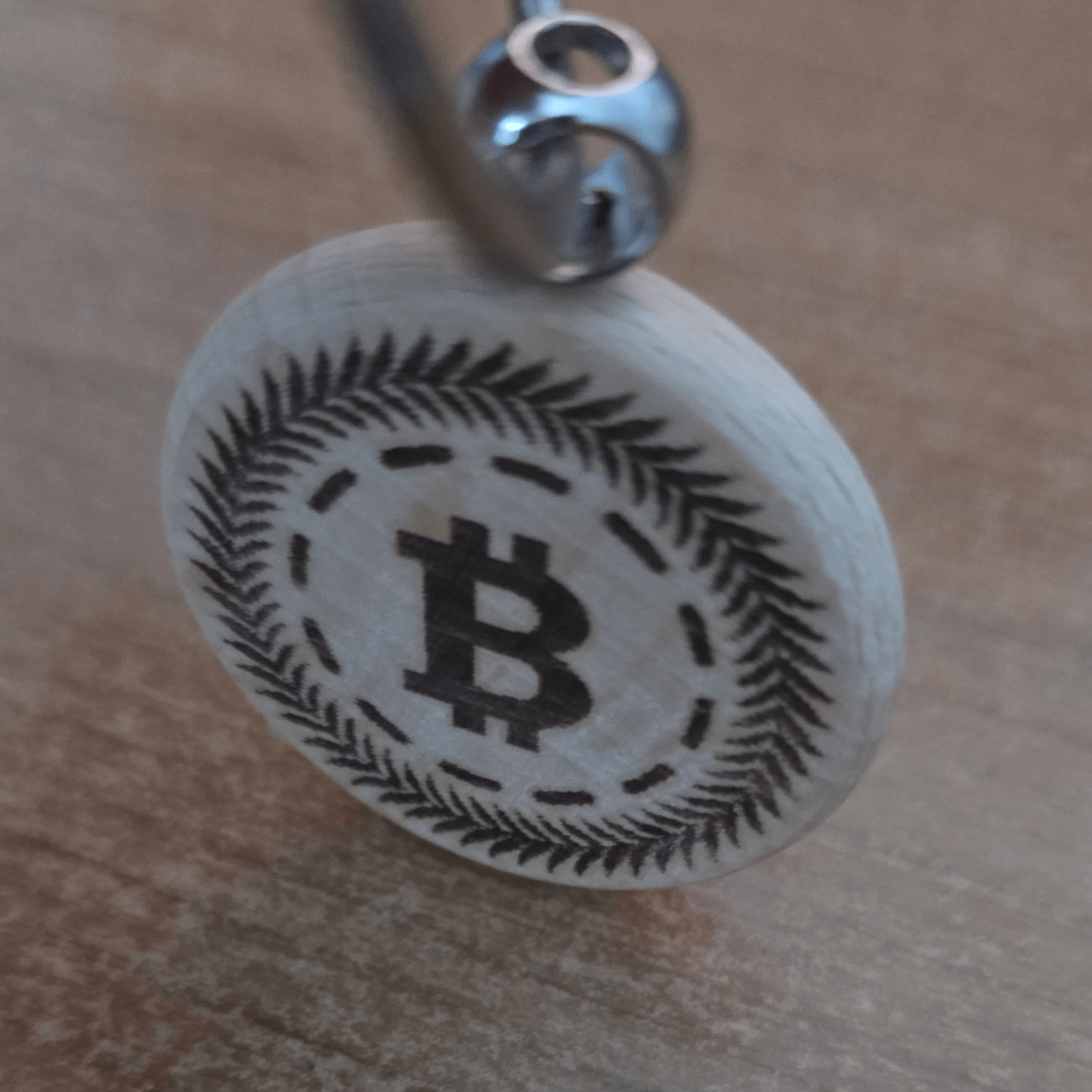 Wooden keychain with stainless-steel split ring on hand