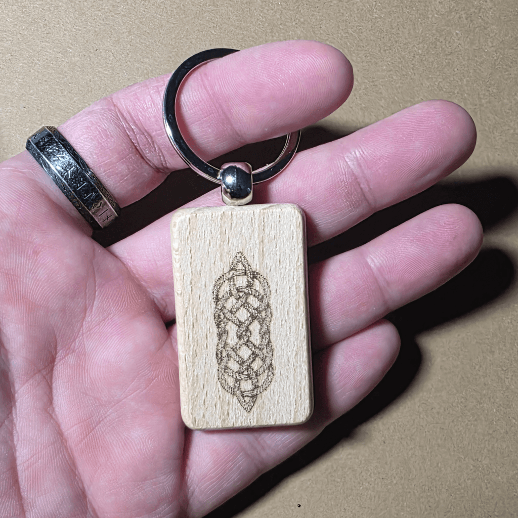 Laser engraved Celtic knot wooden keychain made from beech wood on a neutral background