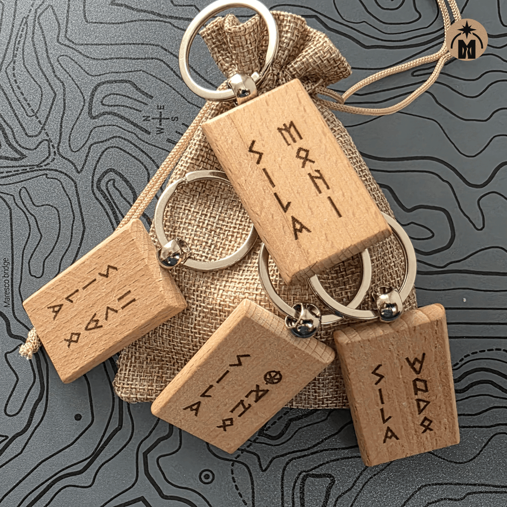 Set of four laser engraved wooden keychains with runic inscriptions in a gift pouch