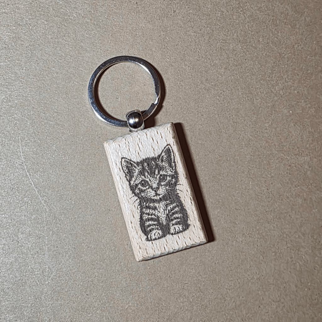 Engraved wooden keychain with cute kitten illustration on beech wood