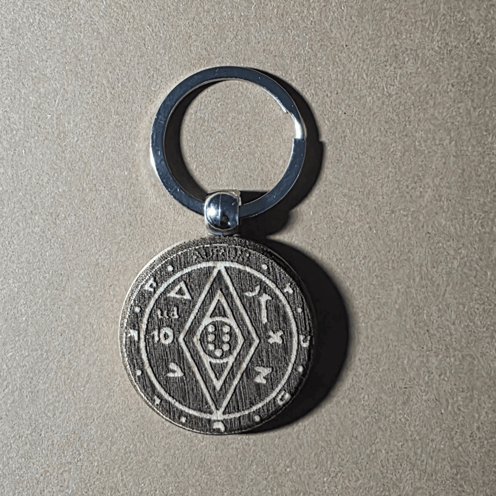 Money-luck talisman motif engraved on round wooden keychain