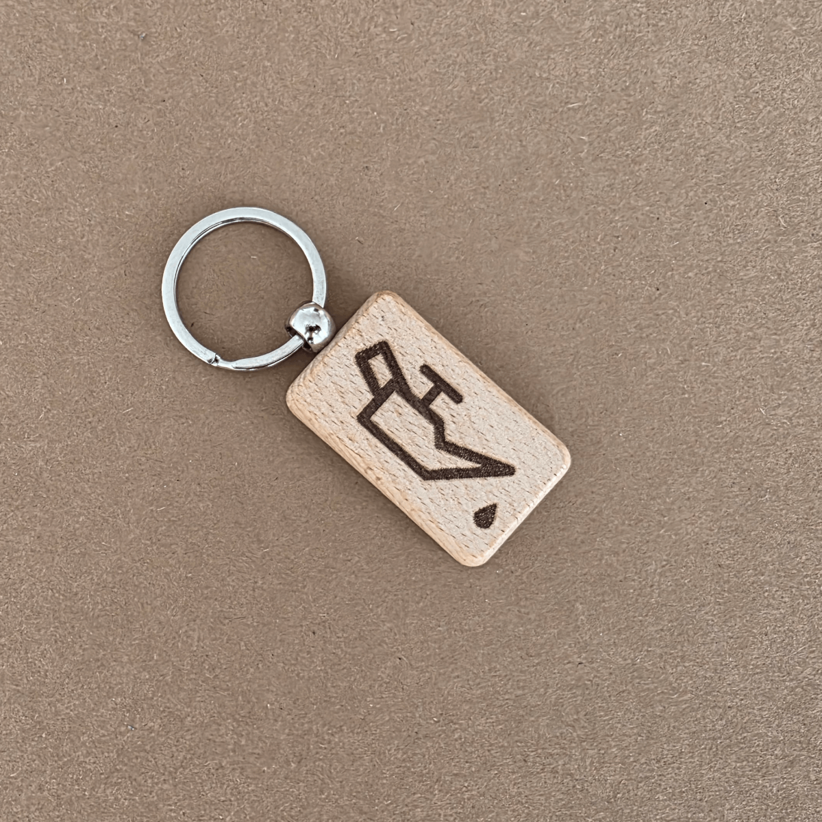 Wooden keychain with laser-engraved engine oil icon on beech