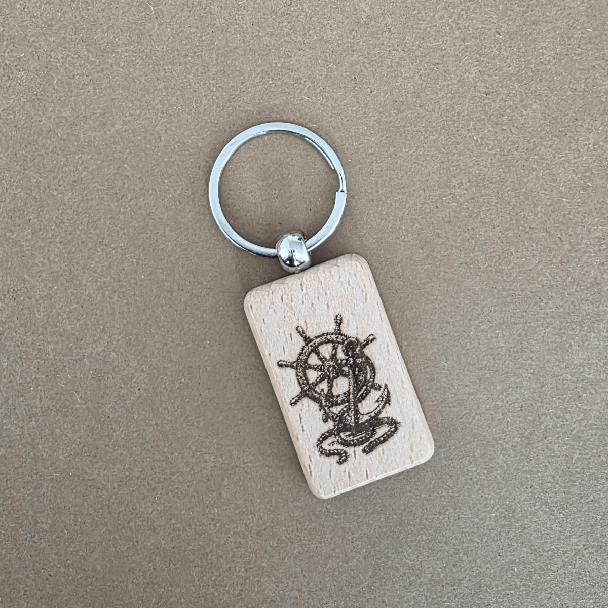 Angled view of engraved wooden keychain with metal split ring