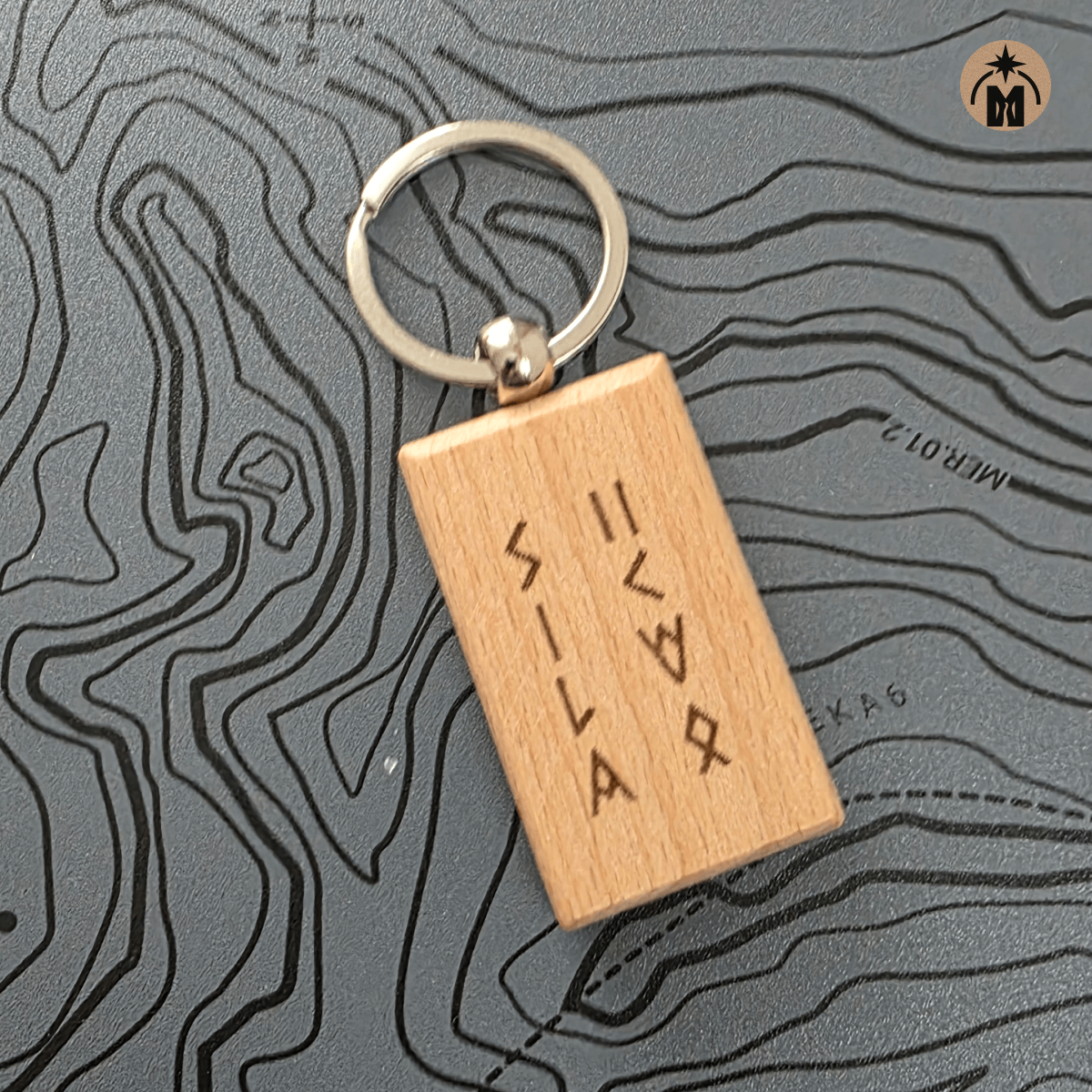 Close-up of engraved wooden keychain “Power of Wind” in Nordic runes with metal ring