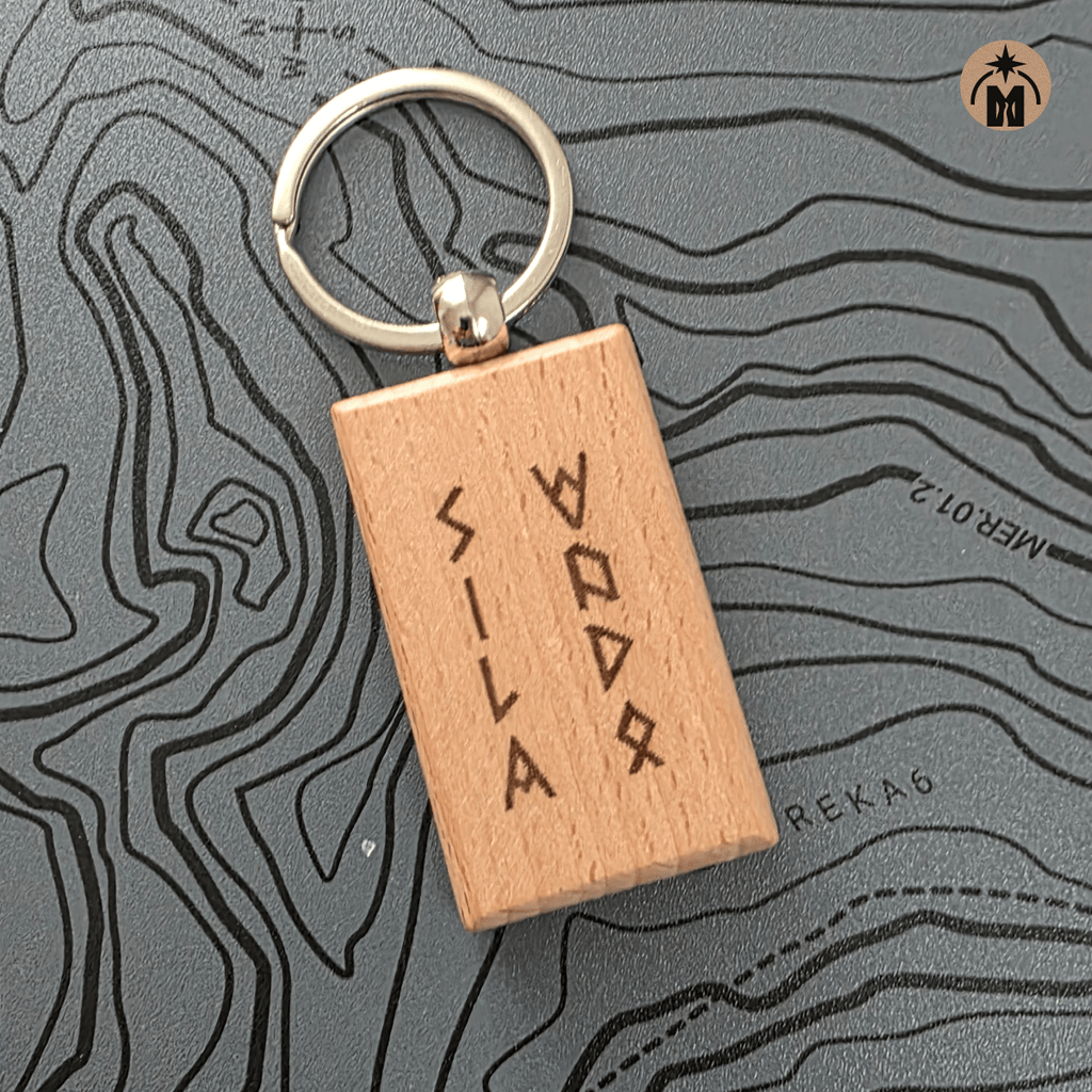 Close-up of wooden key fob with runic inscription Power of Water, metal key ring
