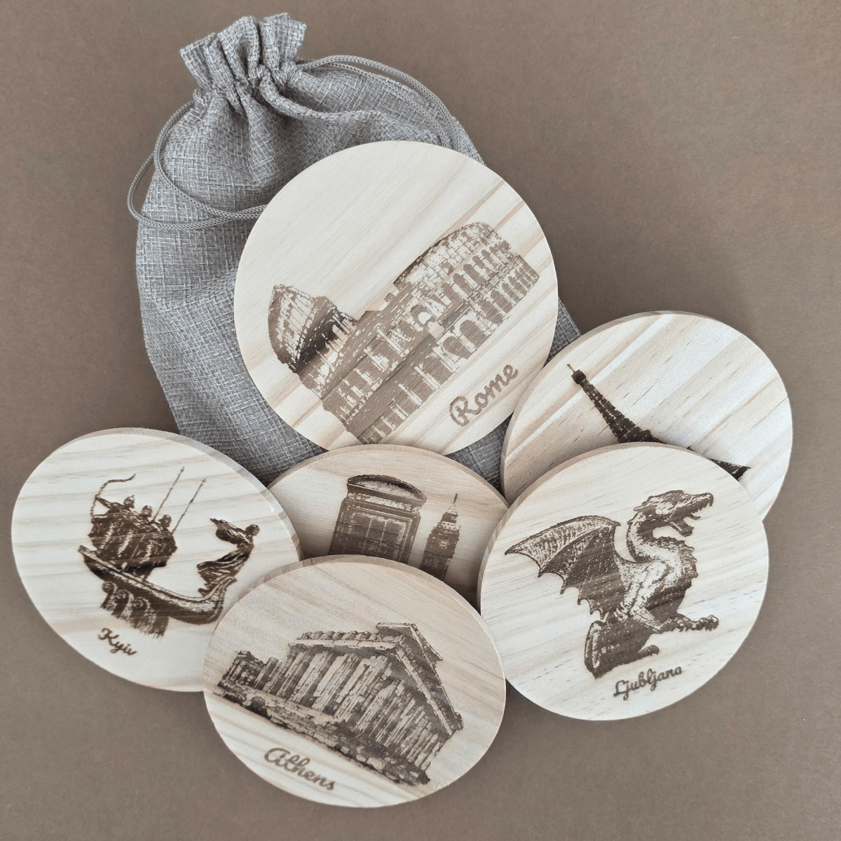 Six engraved wooden coasters with European landmarks and gift pouch