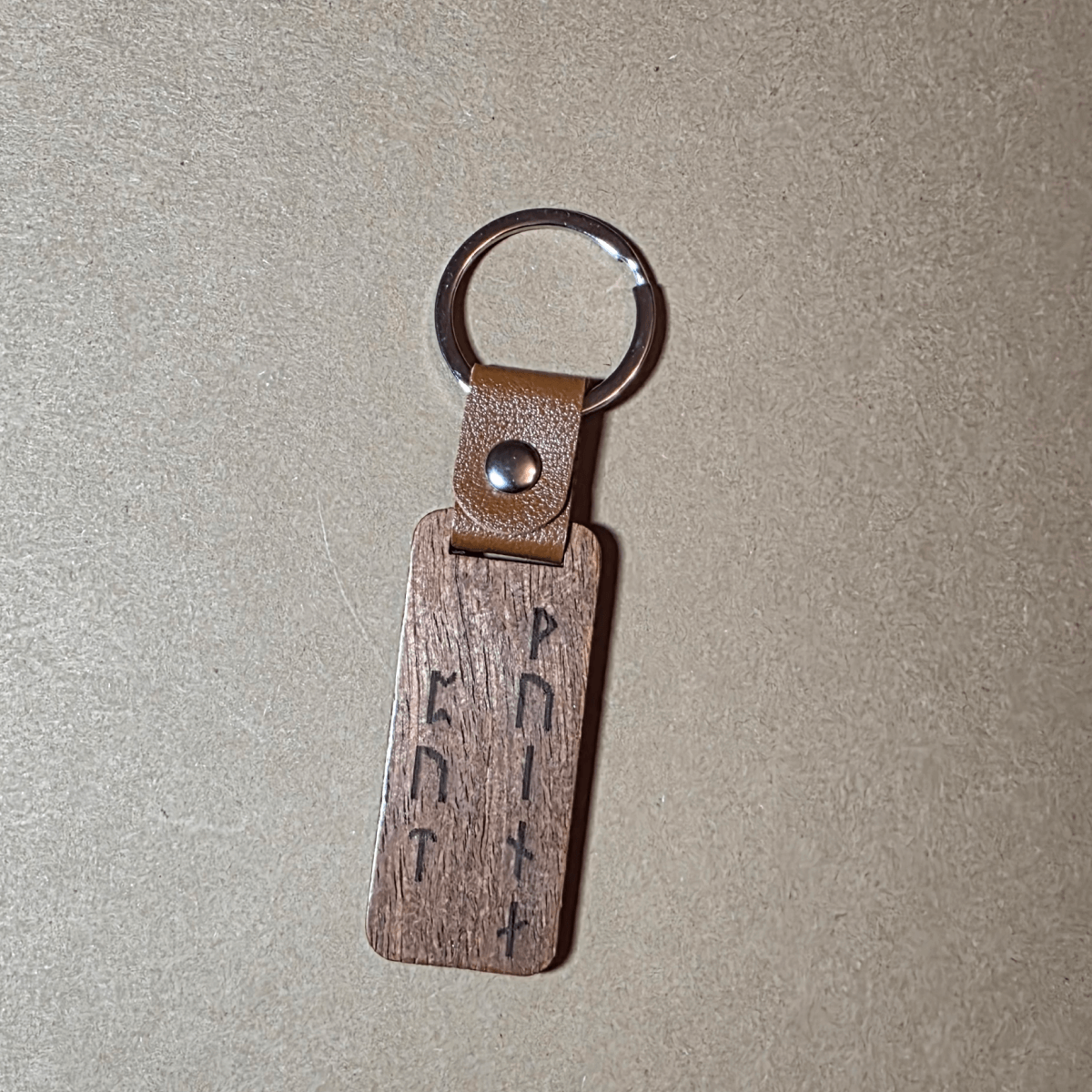 Dark wood Viking keychain with leather strap and runic inscription “Warrior’s Path”