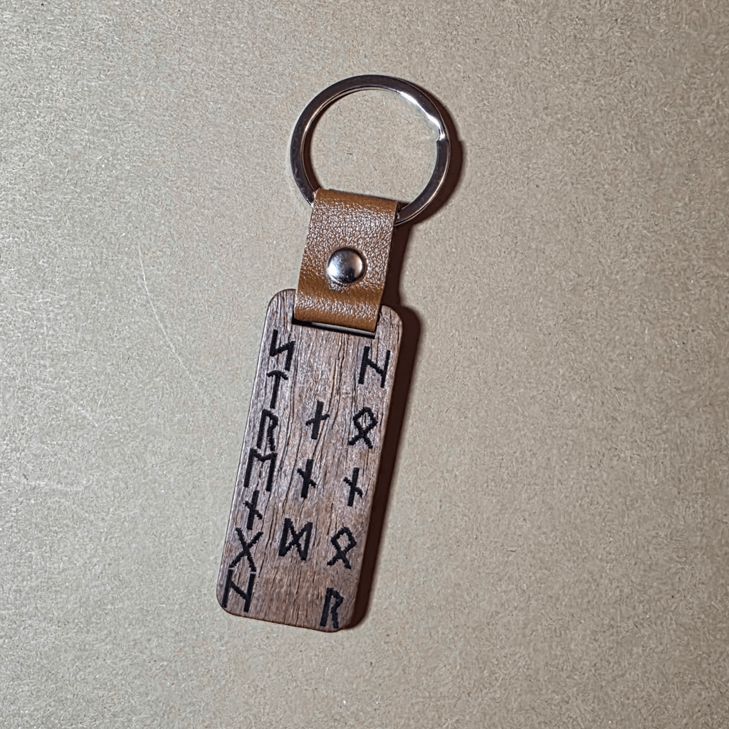 Engraved Viking warrior head and runic inscription Strength and Honor on dark wooden keyring
