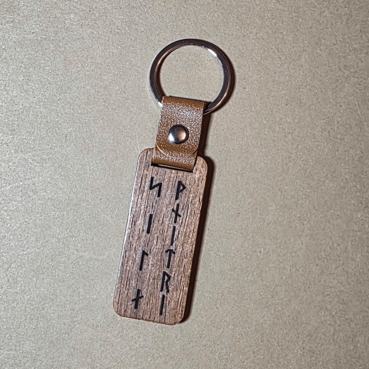 Walnut Viking keychain with runic inscription Strength Within on leather loop