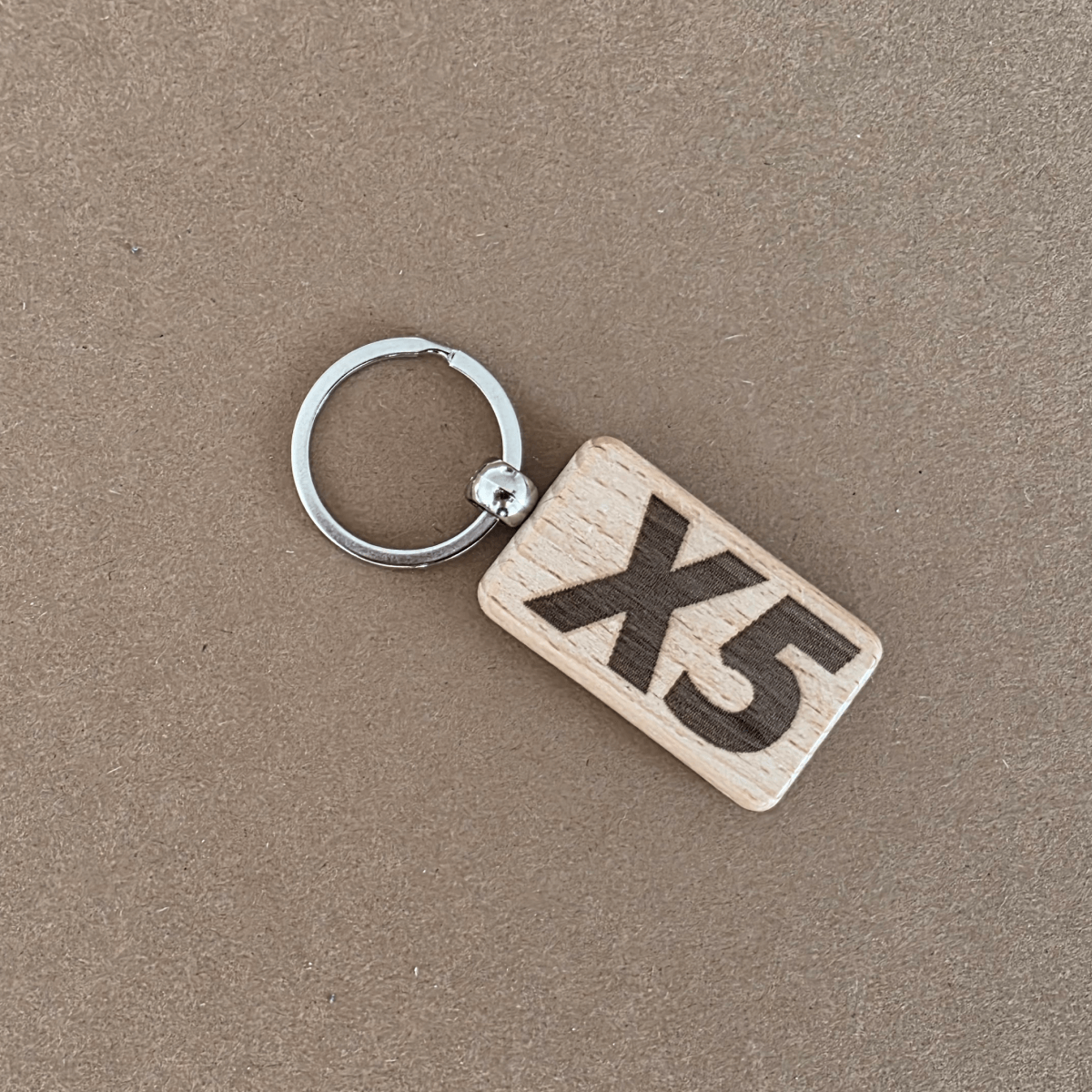 Wooden keychain with ‘X5’ engraving — reverse side