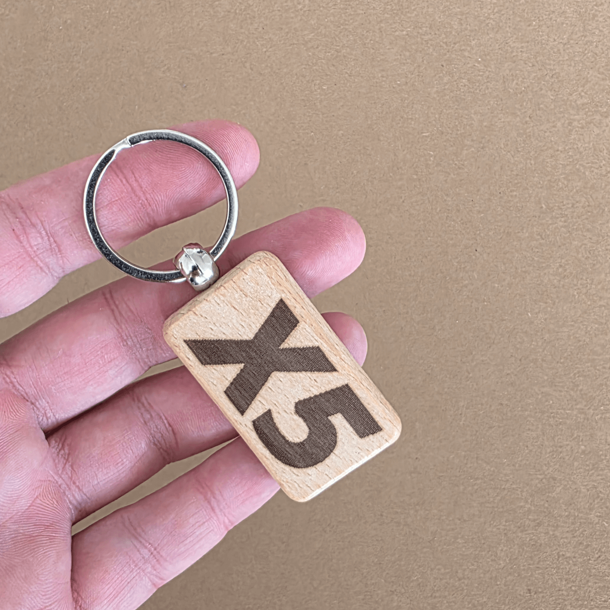 Wooden keychain with ‘X5’ engraving — reverse side
